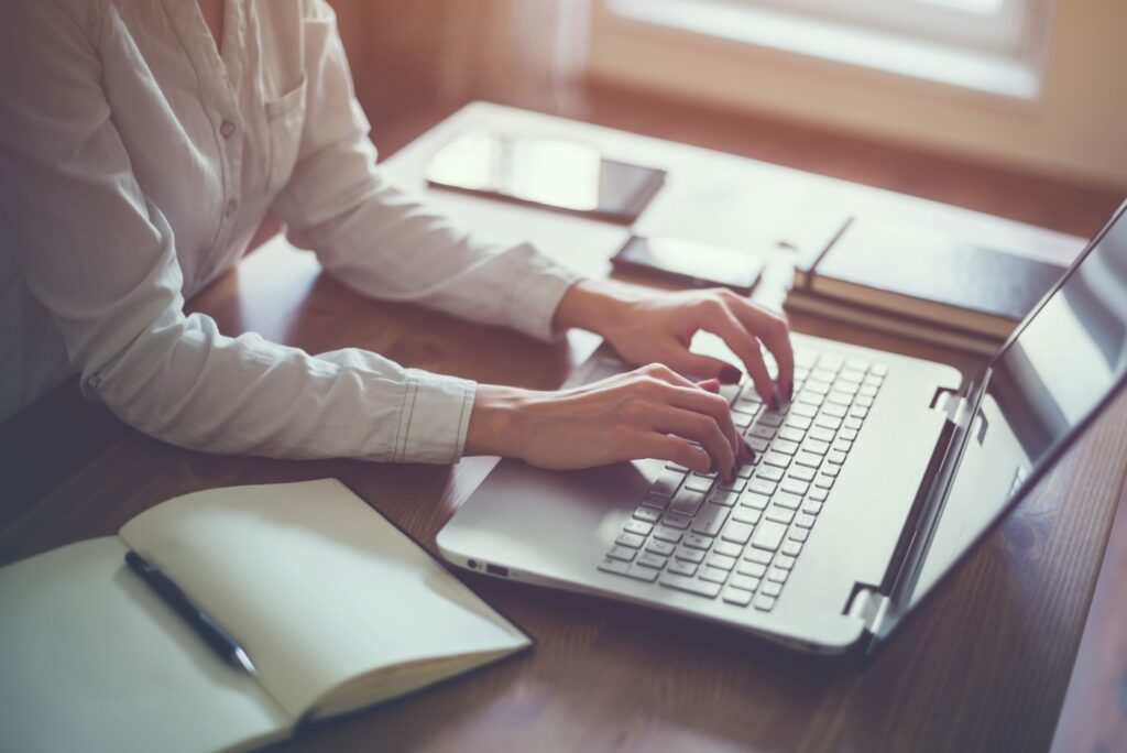 Person typing on their laptop