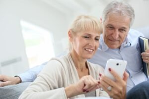 Mature adults look at smartphone
