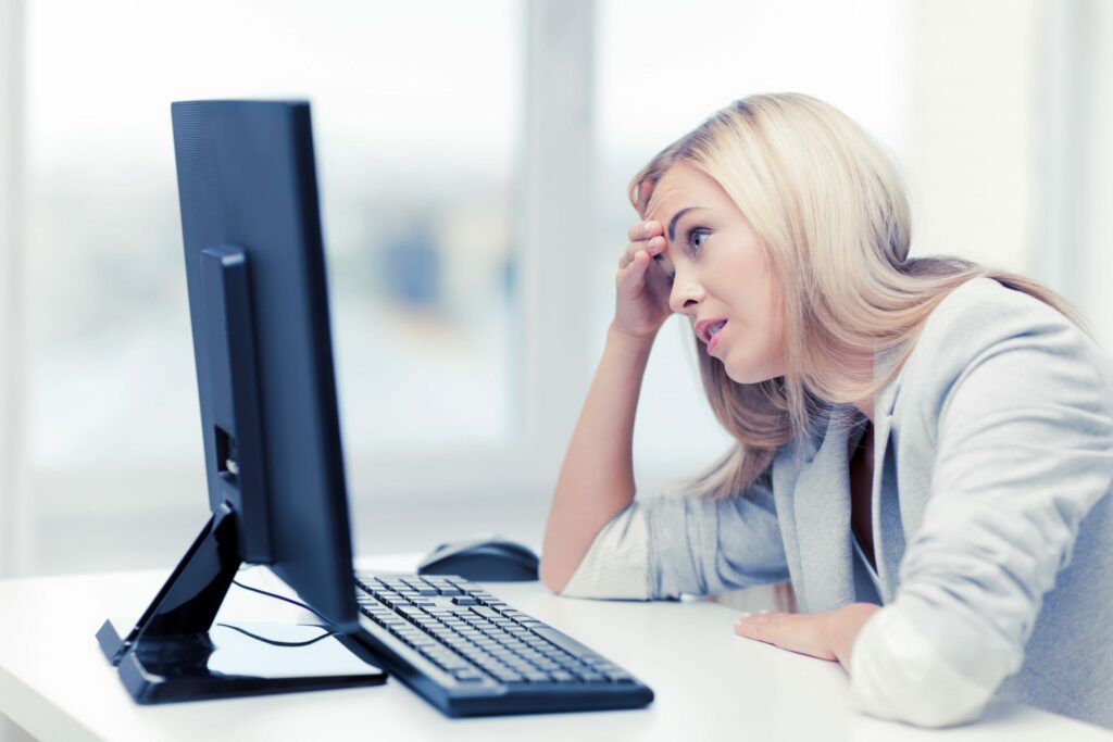 Woman is frustrated while looking at her computer