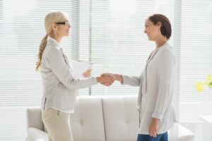 Hearing professional shakes patient's hand