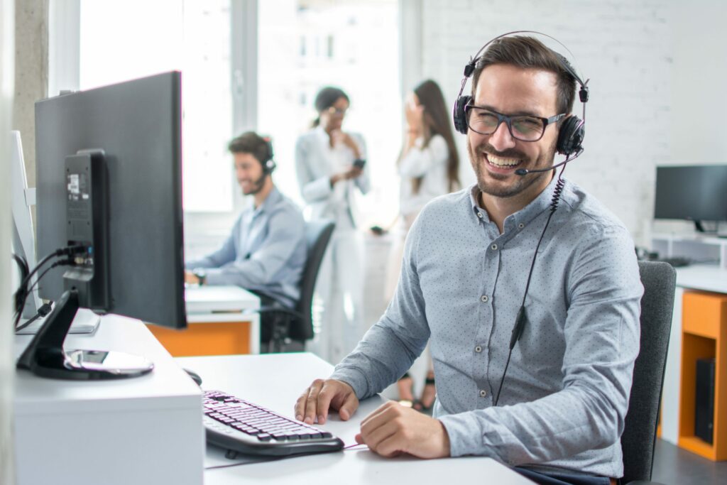 Tech support staff member smiles while on a call