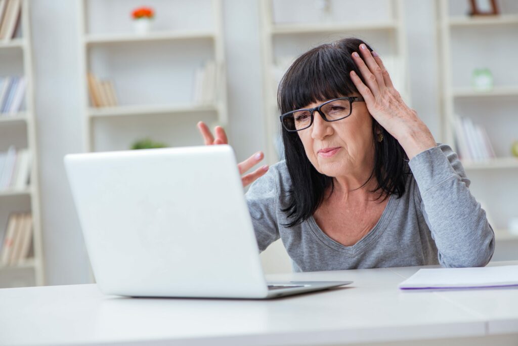 Frustrated woman looks at computer